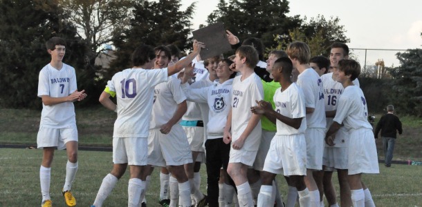 BHS Soccer team celebrates after receiving champion trophy.