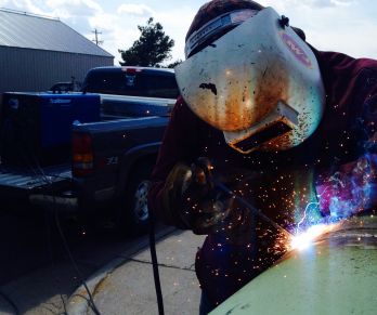 Austin Chavez welding at school practicing on a 24 pipe using a welder generator 