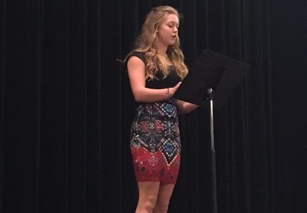Sophomore Sydney Bergan performs Healing at the annual Poetry Slam in the PAC.