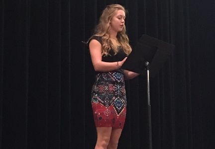 Sophomore Sydney Bergan performs "Healing" at the annual Poetry Slam in the PAC.