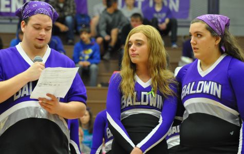 Senior Spencer Young recognizing senior Aliyah Johnson at the home basketball game. 