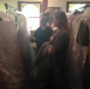 Tobie Roberts and her mother Michelle looking through their inventory of dresses