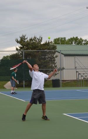 Sophomore JV player Tucker Austin sends a powerful serve to his opponent at the De Soto courts.