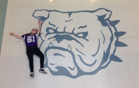 Sophomore Kaela Roberts poses by the bulldog design at the entrance of the building. Courtesy of Isabel Tiller.