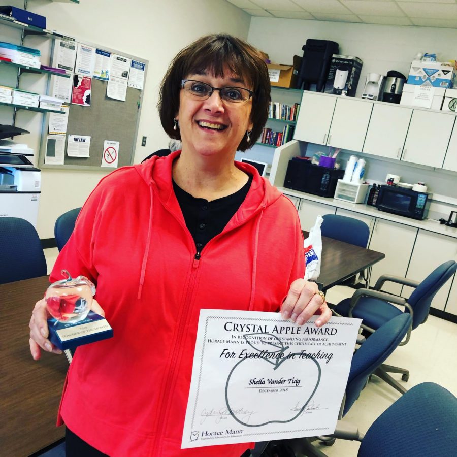 Sheila Vander Tuig holding her Staff of the Month awards.