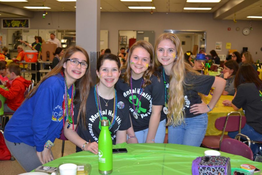 Gracie Bryan, Emily Taylor, Madylin Wolfolk, and Brooke Peterson participating in Mardi Gras. 