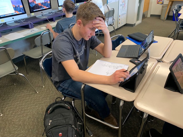 Charlie Reynolds working on Honors Algebra 2 homework. Reynolds is a freshman who has taken many honors classes before.