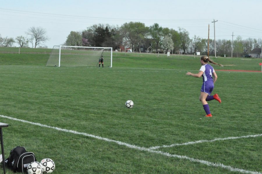 Cambria Crowe is taking the ball down to score.