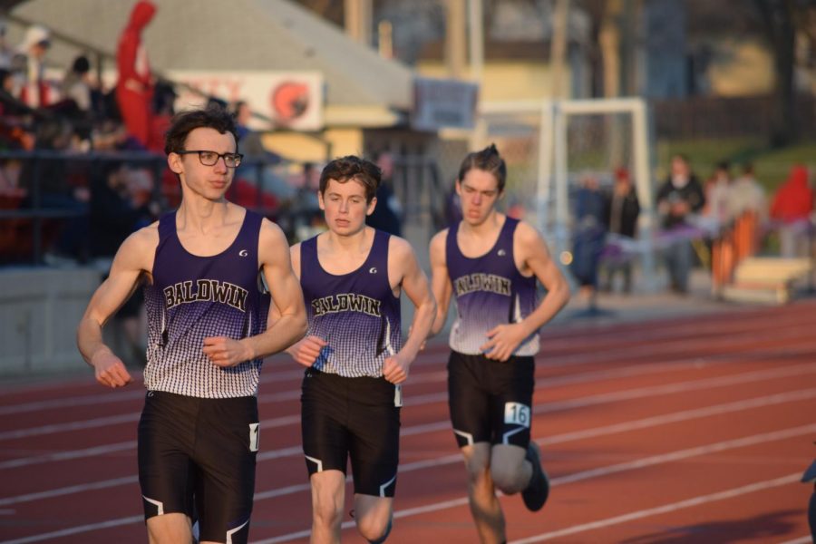 Jude Stacey, Collin Ediger, and Crayton Walters run the mile at the BIT track meet.