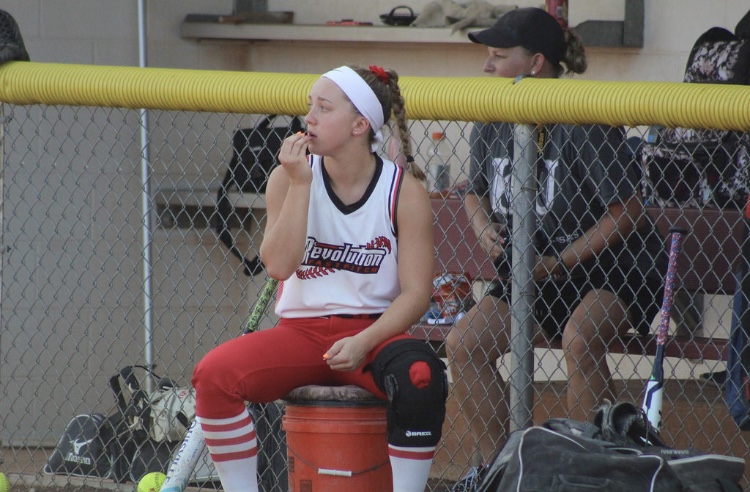 Sophomore Emma Grossoehme pictured eating seeds and watching her teammates. Emma was injured during her club season and made a full recovery before school.