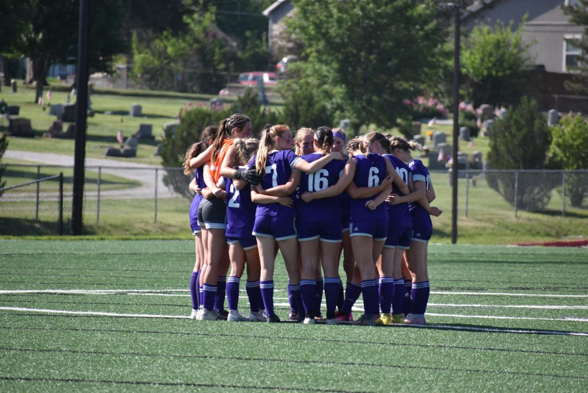 The team in a tight huddle discussing their game plan.