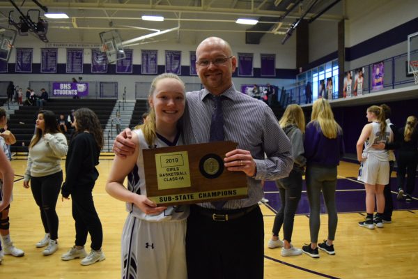 Coach Eric Toot poses with his daughter after winning a sub-state championship.