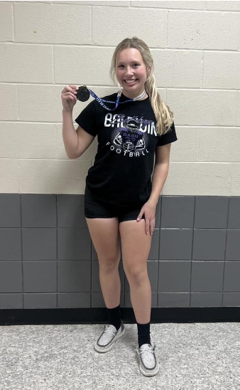 Paige Soper after winning the 4A State Championship, holding her medal.