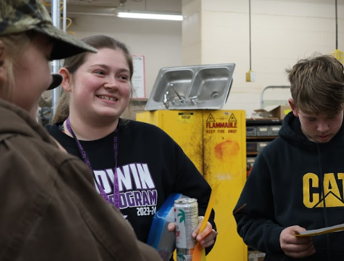 Hoskinsin talks to her students competing in a welding competition.